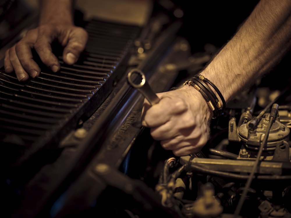 Mechanic using a wrench on an engine