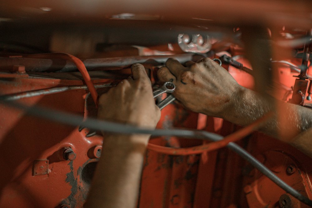 Hands working on vehicle wiring